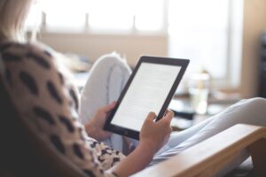 woman-sitting-on-chair-using-black-ipad-196649